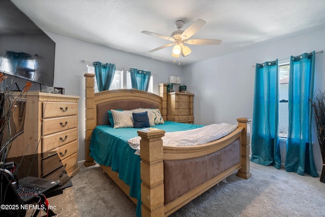 bedroom featuring ceiling fan, a textured ceiling, and carpet flooring