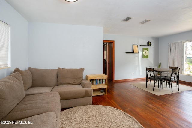 living room featuring dark wood-type flooring