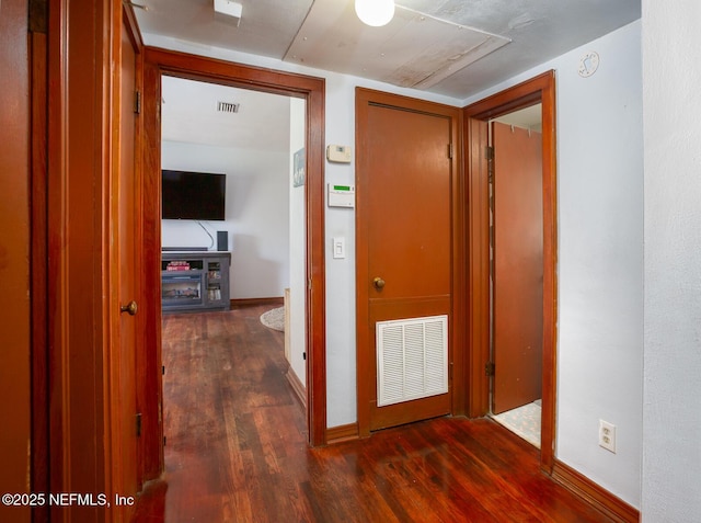 corridor with dark hardwood / wood-style floors