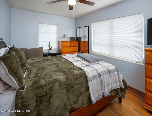 bedroom with ceiling fan and light hardwood / wood-style flooring