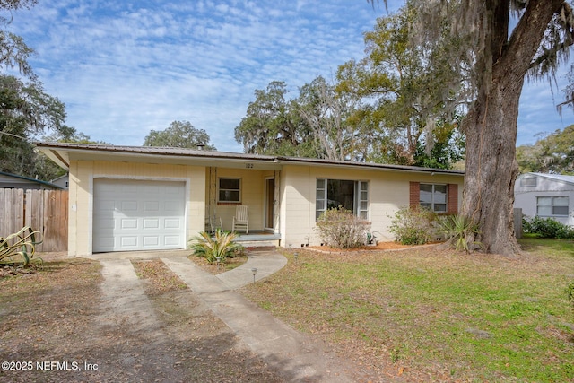 ranch-style home with a front yard and a garage