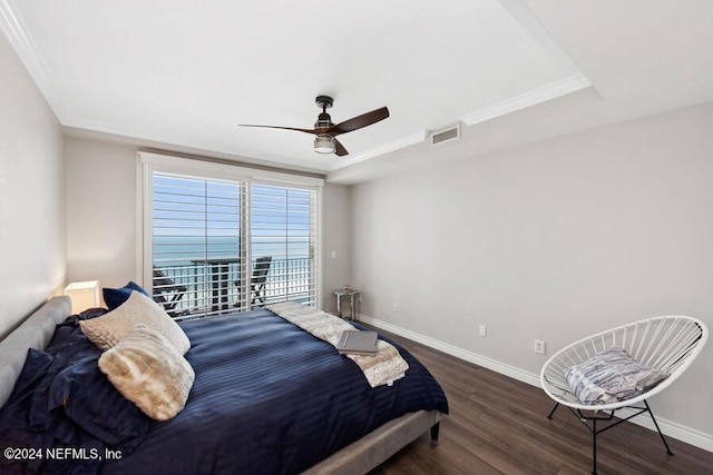 bedroom featuring ceiling fan, dark hardwood / wood-style floors, and a raised ceiling