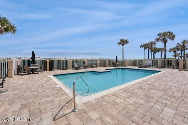 view of pool featuring a patio