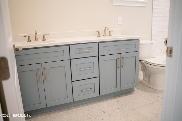 85026 Napeague Dr, Fernandina Beach, FL 32034 - bathroom with double vanity, toilet, and speckled floor