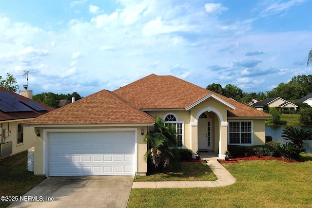 view of front of house featuring a garage and a front lawn