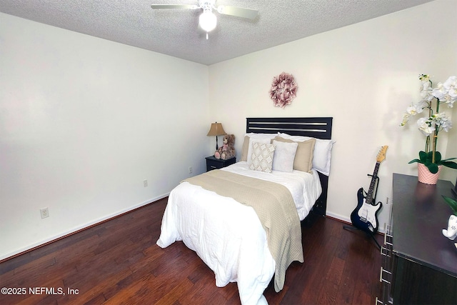 bedroom featuring a textured ceiling, dark wood-type flooring, and ceiling fan