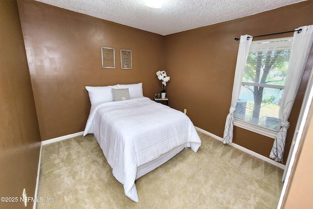 bedroom with carpet and a textured ceiling