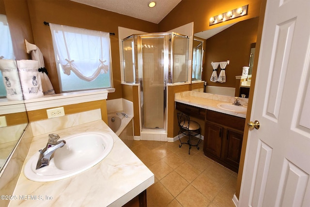 bathroom with lofted ceiling, vanity, tile patterned flooring, and independent shower and bath