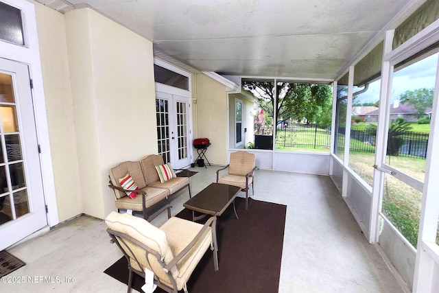 sunroom / solarium featuring plenty of natural light and french doors