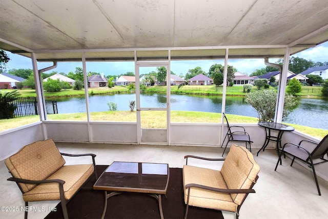 unfurnished sunroom featuring a water view