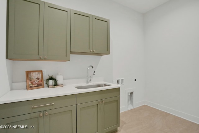 clothes washing area with sink, electric dryer hookup, cabinets, and washer hookup