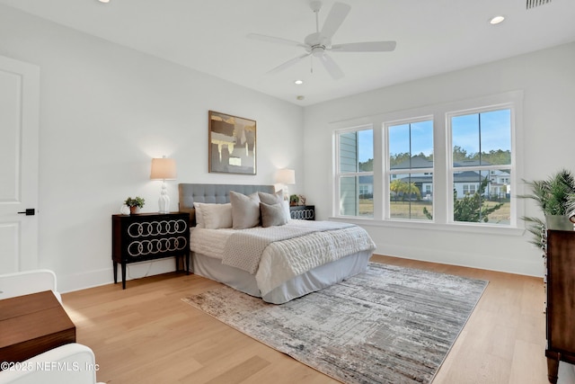 bedroom with ceiling fan and hardwood / wood-style floors