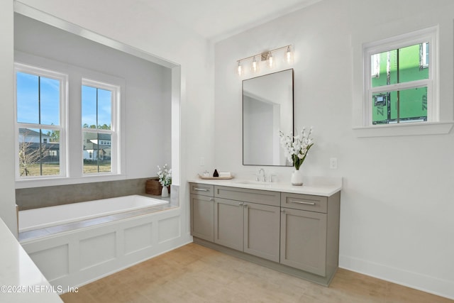 bathroom with vanity and a washtub