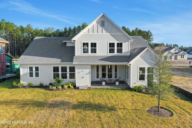 rear view of property with a yard and a patio