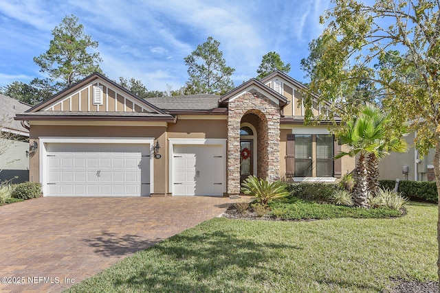 view of front of property with a garage and a front yard