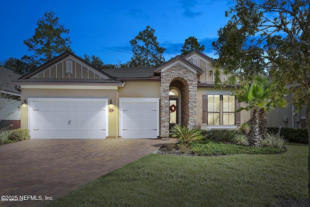 view of front of property featuring a garage and a yard