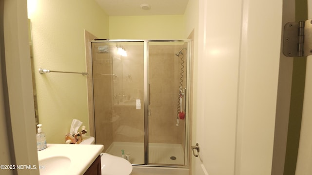 bathroom featuring vanity, toilet, and walk in shower