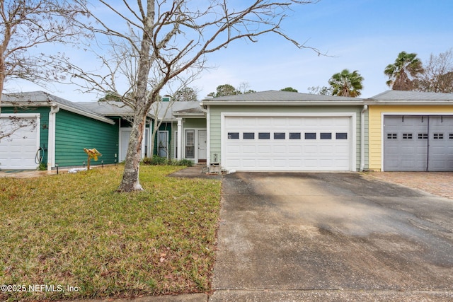 single story home featuring a garage and a front lawn