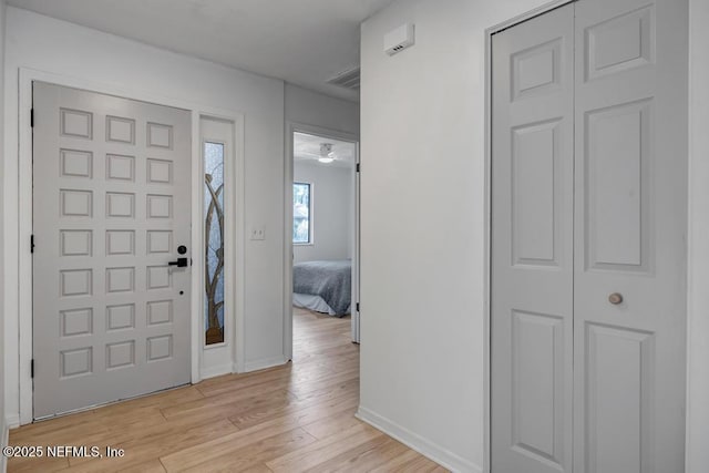 foyer entrance with light wood-type flooring