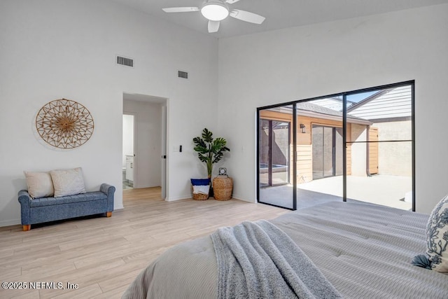 bedroom featuring ceiling fan, high vaulted ceiling, access to exterior, and light hardwood / wood-style floors