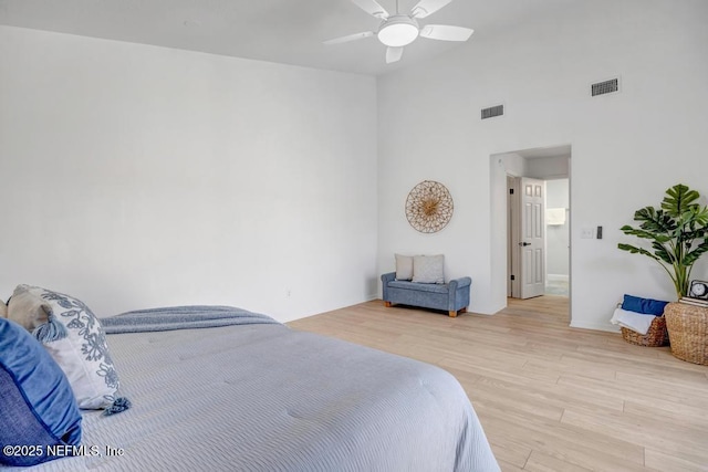 bedroom featuring ceiling fan, lofted ceiling, and light hardwood / wood-style floors