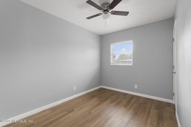 unfurnished room with wood-type flooring and ceiling fan