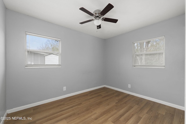 unfurnished room with ceiling fan and dark hardwood / wood-style flooring