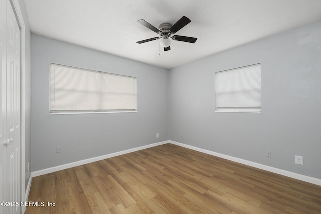 unfurnished room with ceiling fan and light wood-type flooring