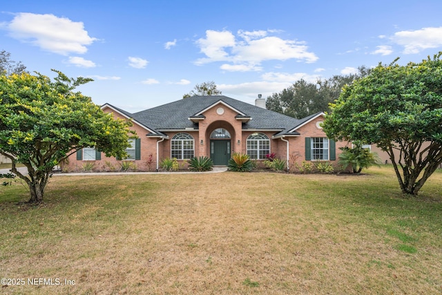 ranch-style home with a front lawn