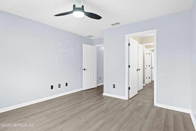 unfurnished bedroom featuring ceiling fan and light hardwood / wood-style flooring