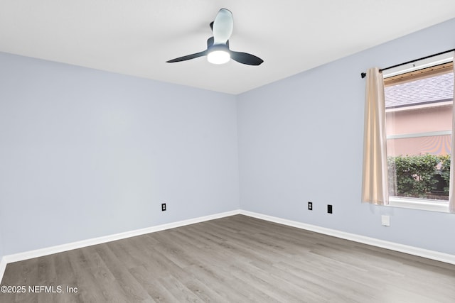 empty room with hardwood / wood-style flooring and ceiling fan