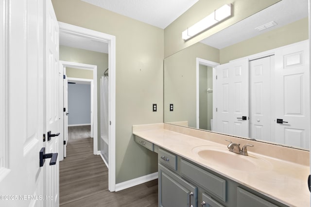 bathroom with vanity and wood-type flooring