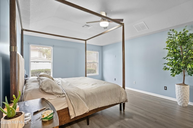 bedroom with dark wood-type flooring, ceiling fan, and multiple windows