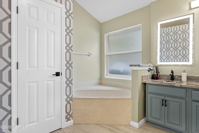 bathroom with vanity and a tub to relax in