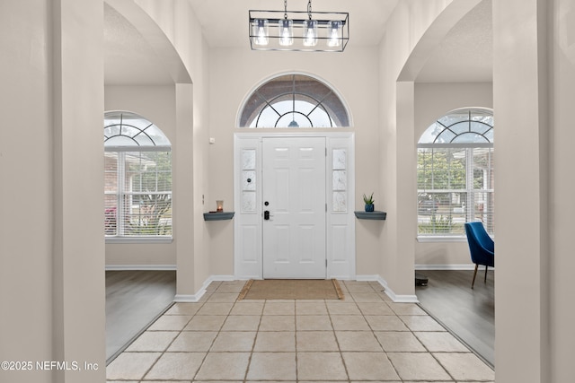 tiled foyer entrance with a healthy amount of sunlight