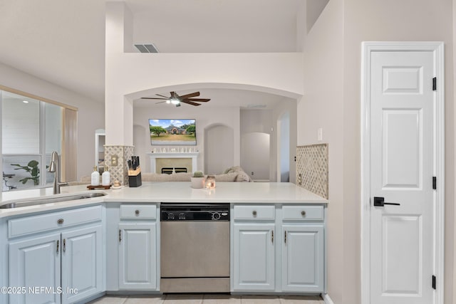 kitchen featuring dishwasher, sink, ceiling fan, and kitchen peninsula