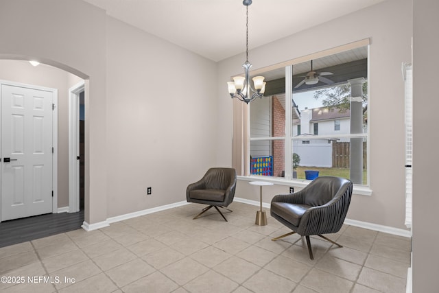 living area with a chandelier and light tile patterned flooring