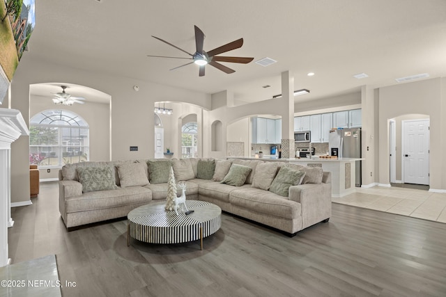 living room featuring ceiling fan and light hardwood / wood-style flooring