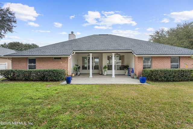 rear view of property with ceiling fan, a yard, and a patio