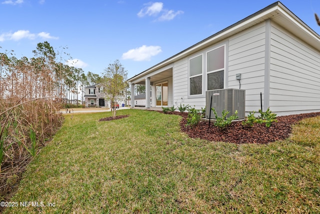 view of yard with a porch and central air condition unit