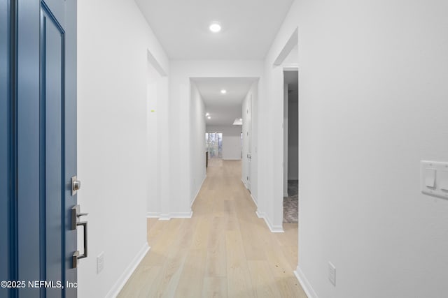 corridor with light hardwood / wood-style flooring