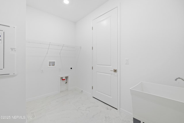 clothes washing area with washer hookup, sink, and hookup for an electric dryer