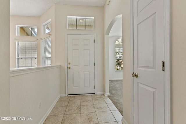 carpeted entryway with a healthy amount of sunlight