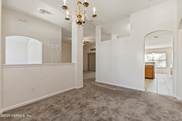 carpeted empty room featuring vaulted ceiling and ceiling fan