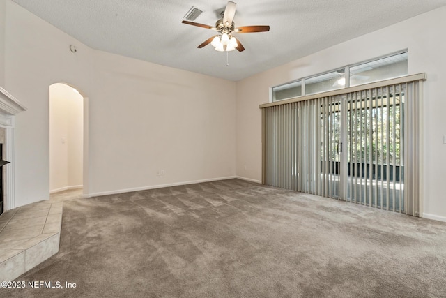 unfurnished living room with carpet floors, a textured ceiling, and ceiling fan