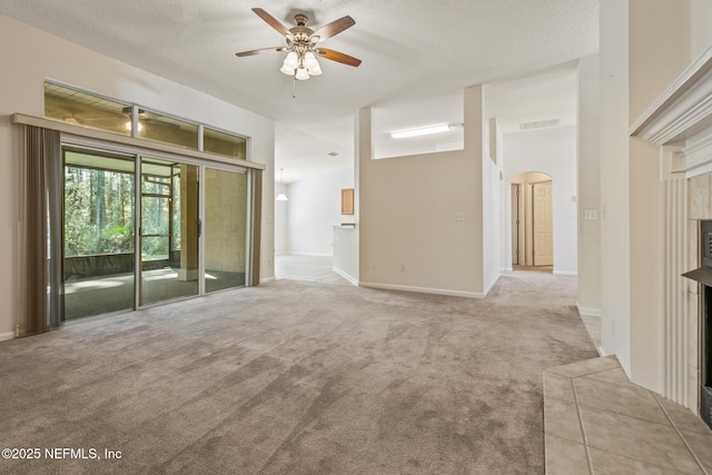 empty room featuring light carpet, a textured ceiling, and ceiling fan