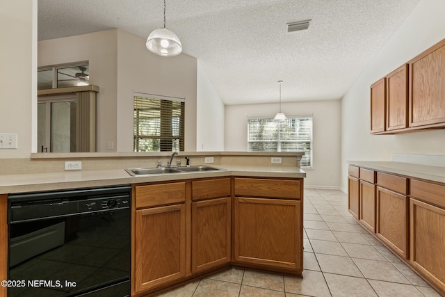 kitchen with pendant lighting, light tile patterned flooring, dishwasher, and sink