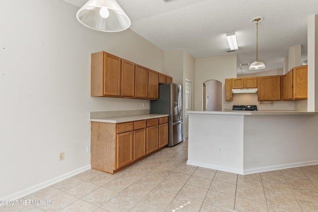 kitchen featuring range, decorative light fixtures, stainless steel fridge with ice dispenser, a textured ceiling, and light tile patterned floors