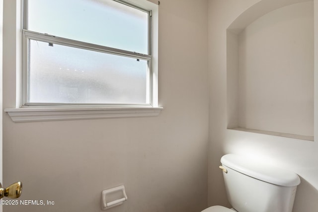 bathroom with plenty of natural light and toilet