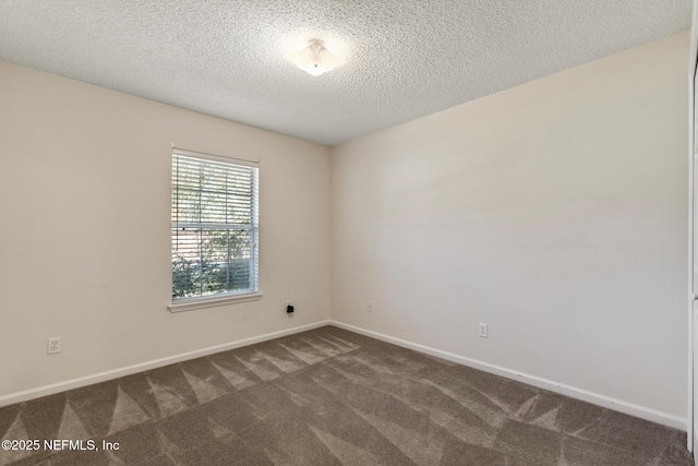 carpeted empty room with a textured ceiling